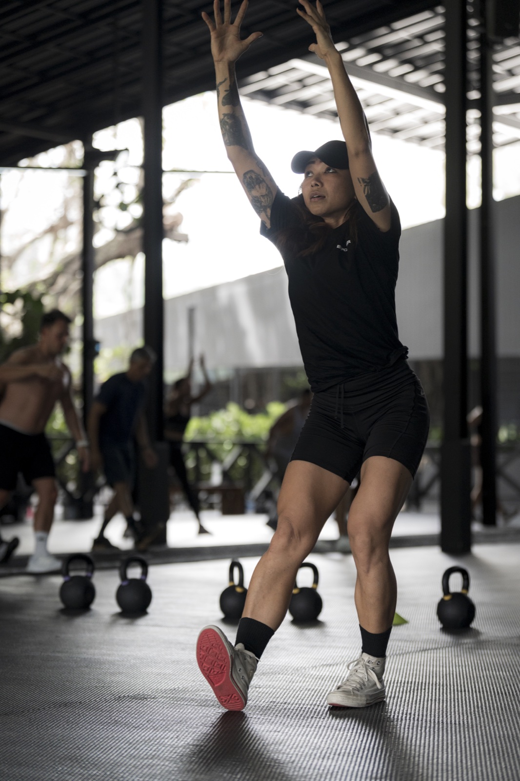 Som demonstrating movement during a HIIT class at EMPOWER