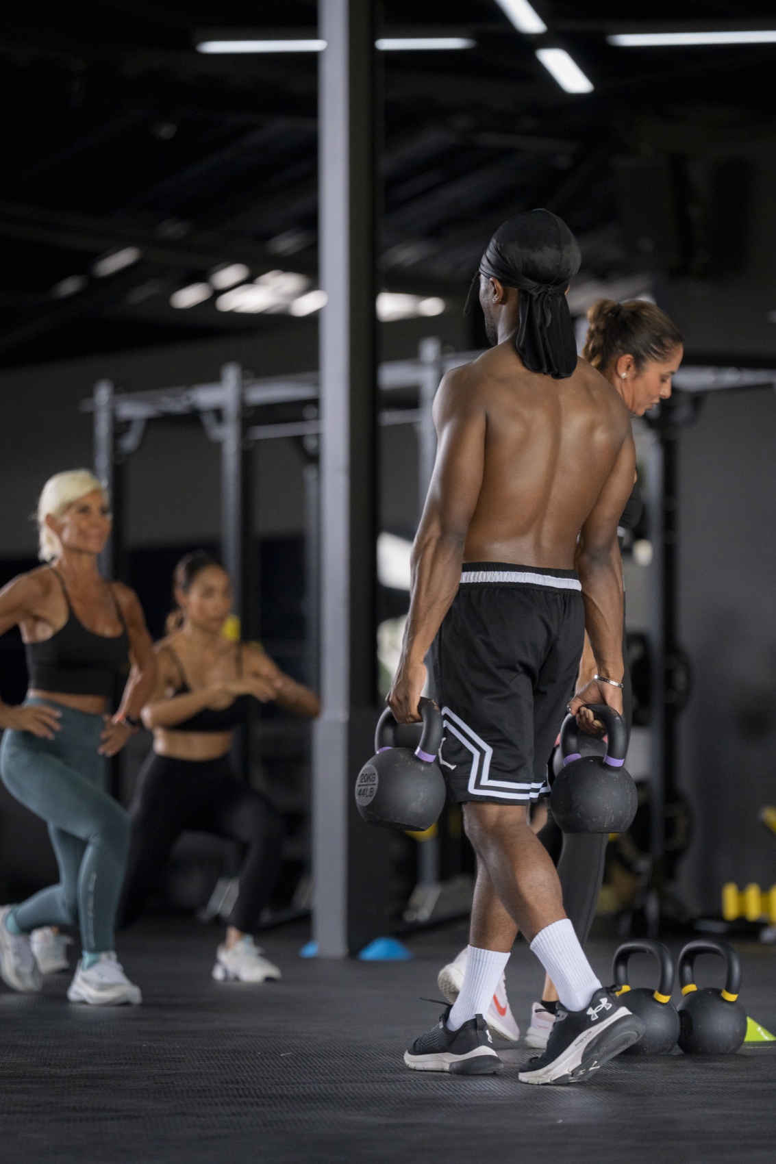 Athlete carrying kettlebells in a HIIT class