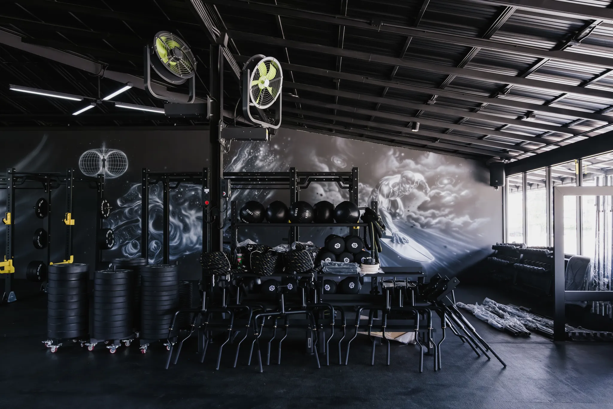 Power racks and training stations in front of the EMPOWER graffiti wall