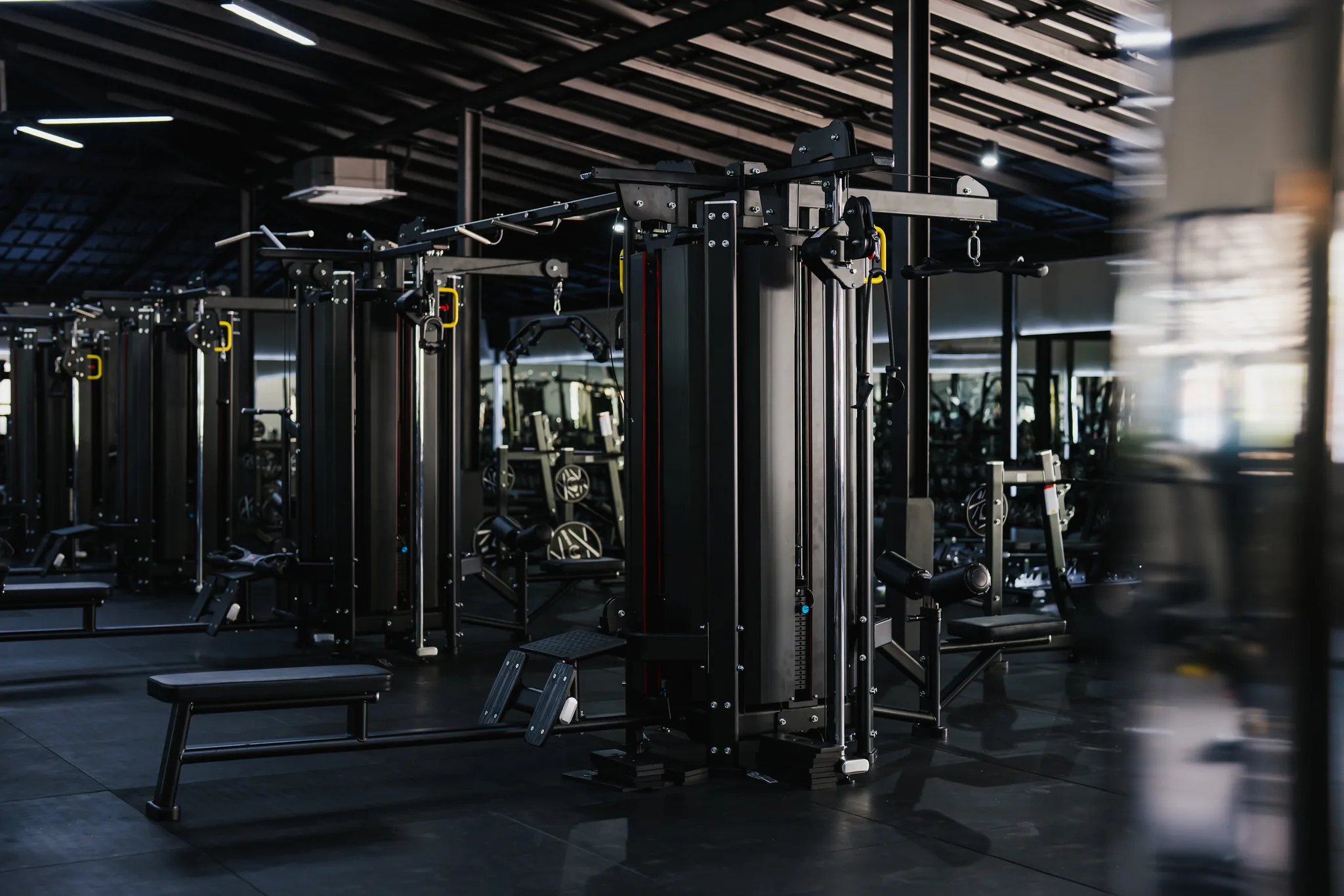 Cable towers and benches on the EMPOWER Gym floor