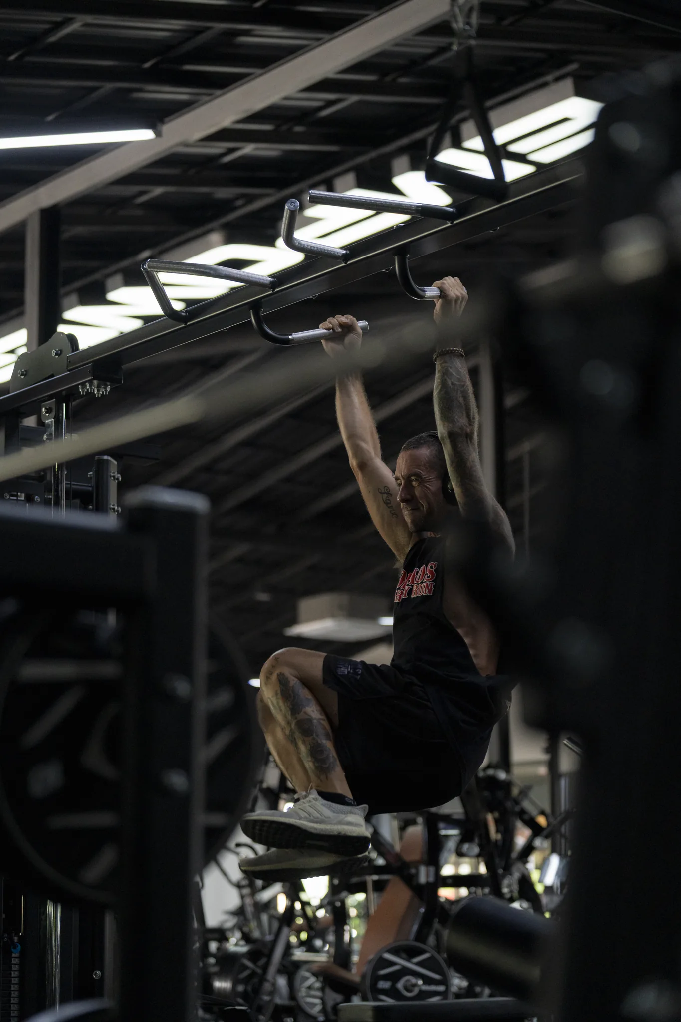EMPOWER member performing a hanging knee raise on the cable rig