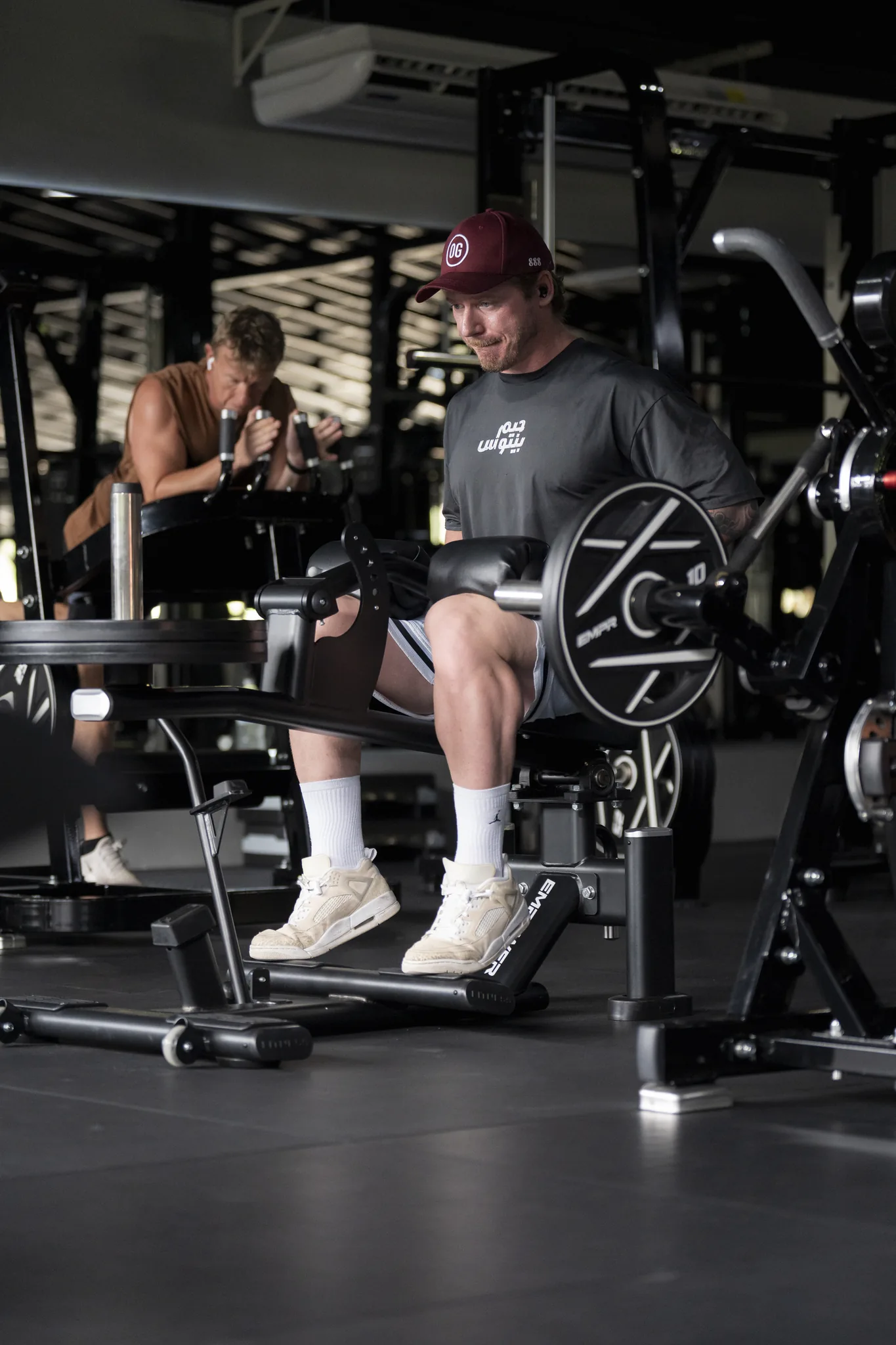 EMPOWER member training on a plate-loaded leg extension machine in Kamala