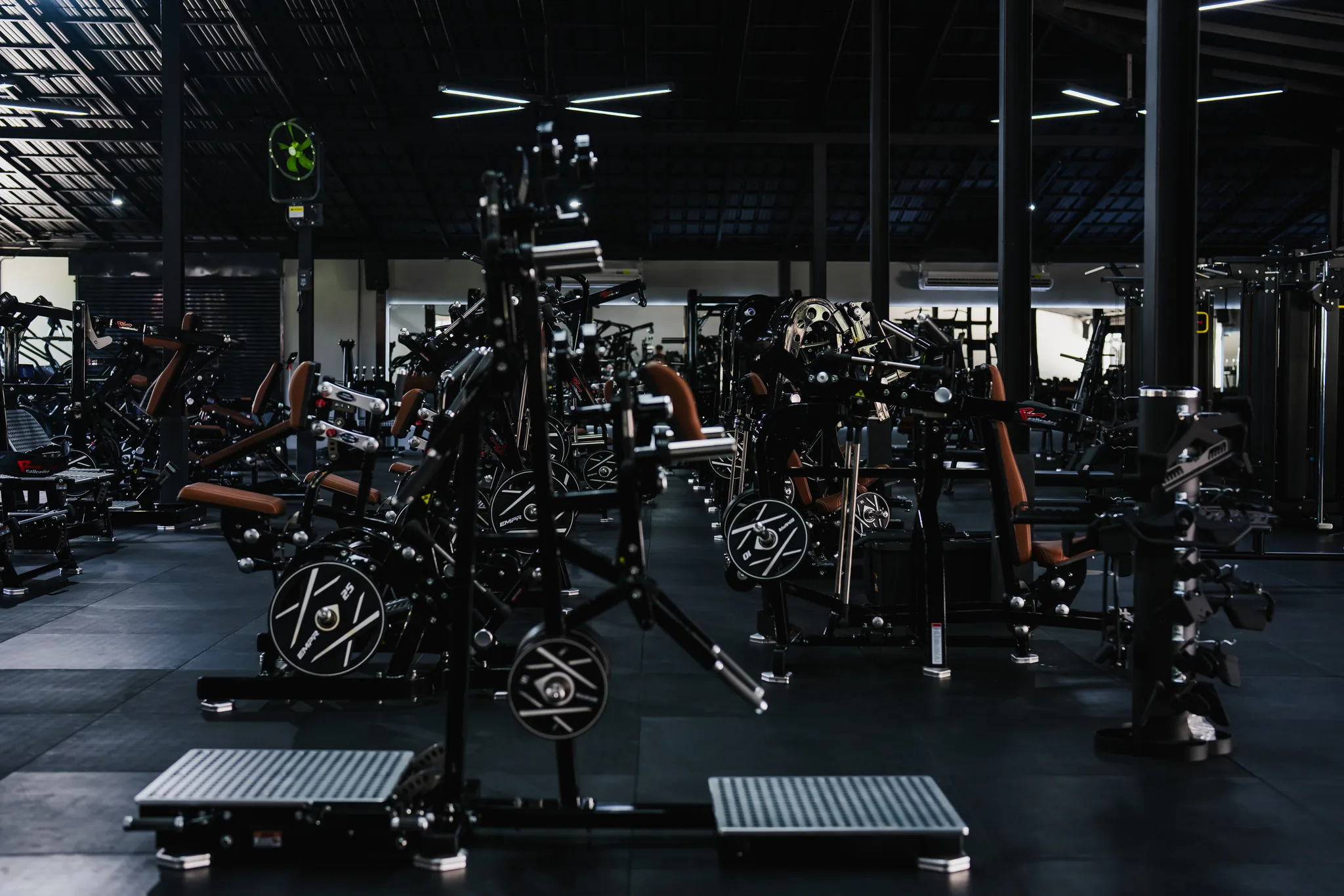 Wide view across the plate-loaded strength floor at EMPOWER Gym Kamala