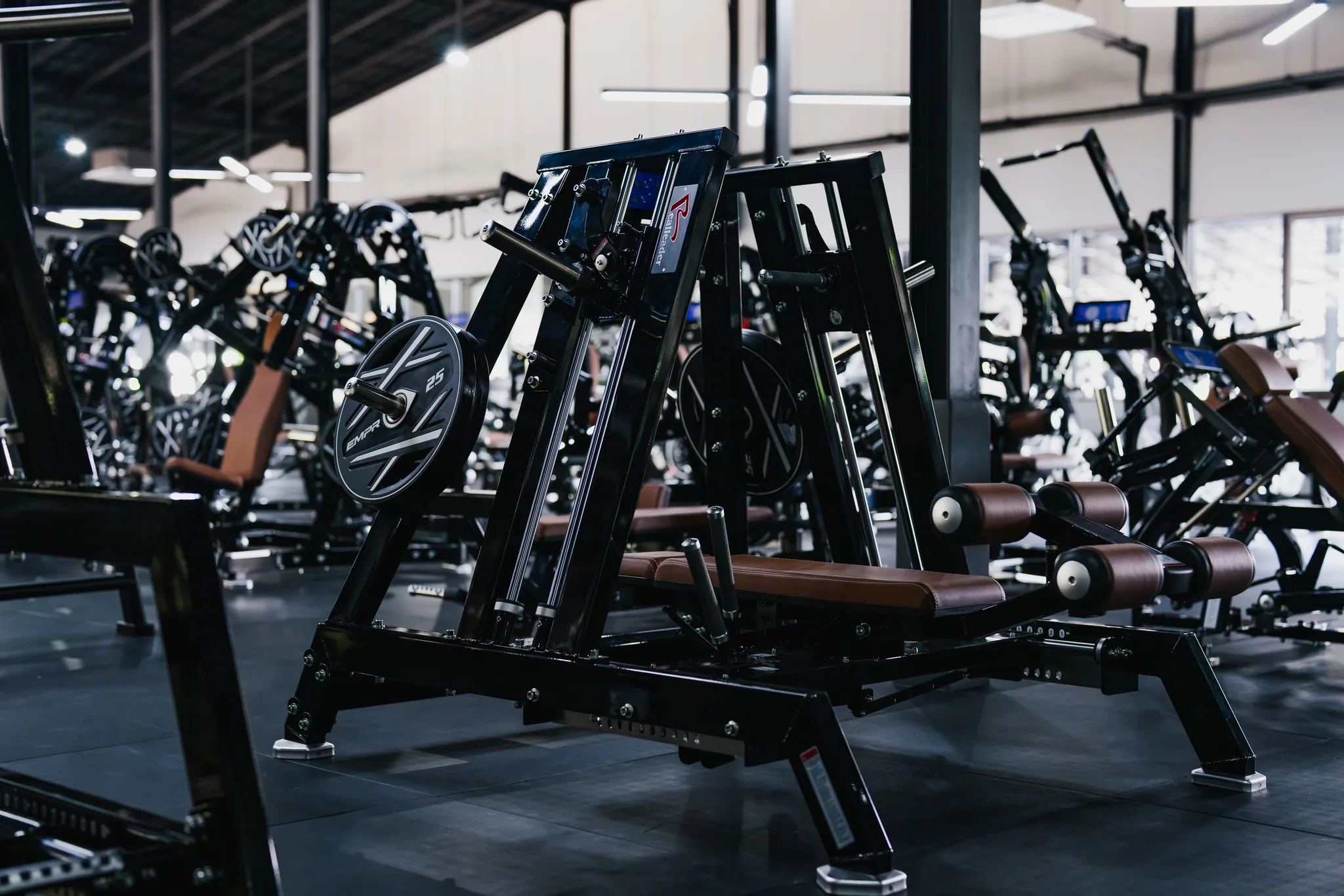 Plate-loaded strength machines on the EMPOWER Gym floor