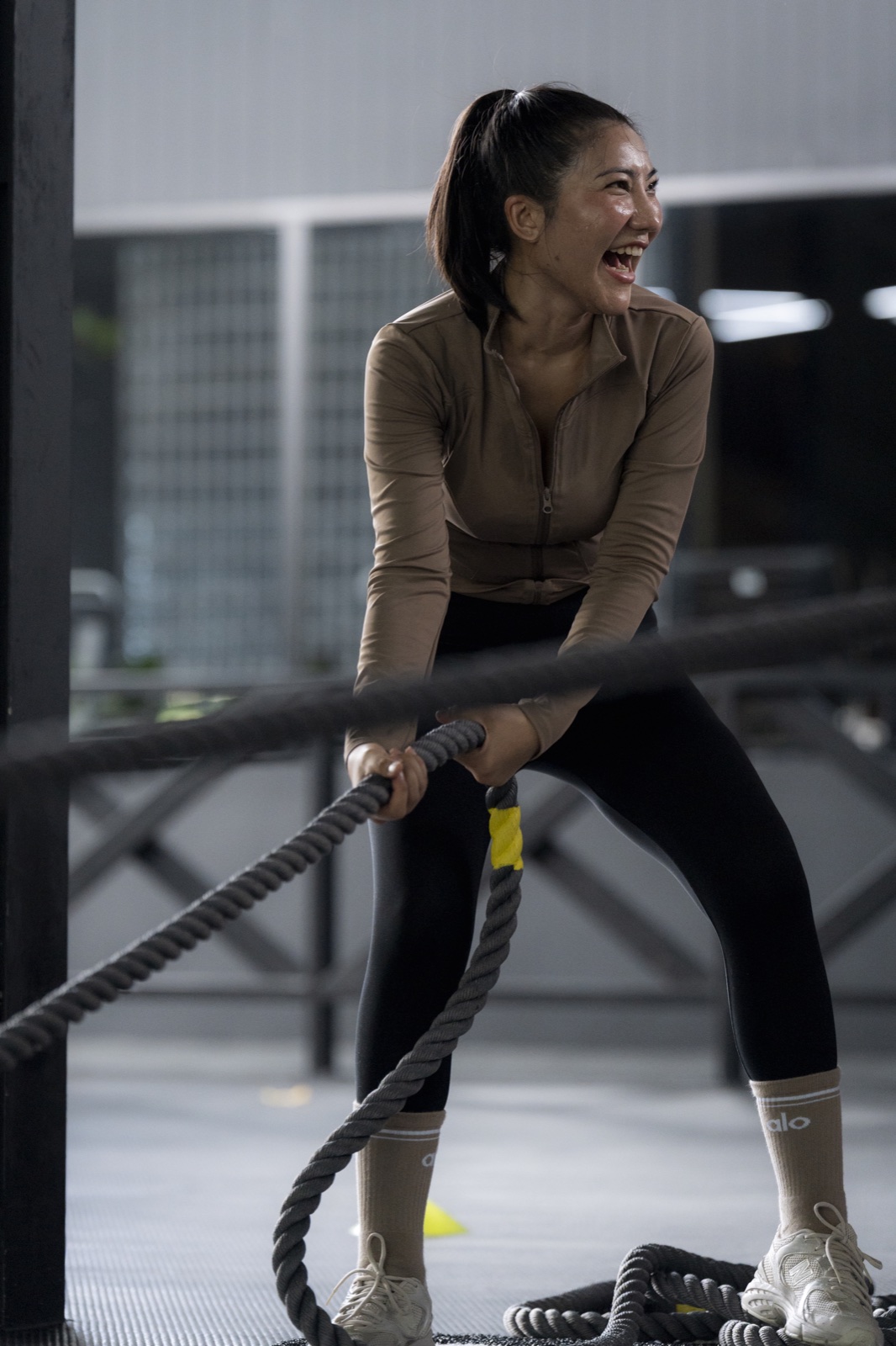 Athlete smiling while completing a functional fitness workout at EMPOWER