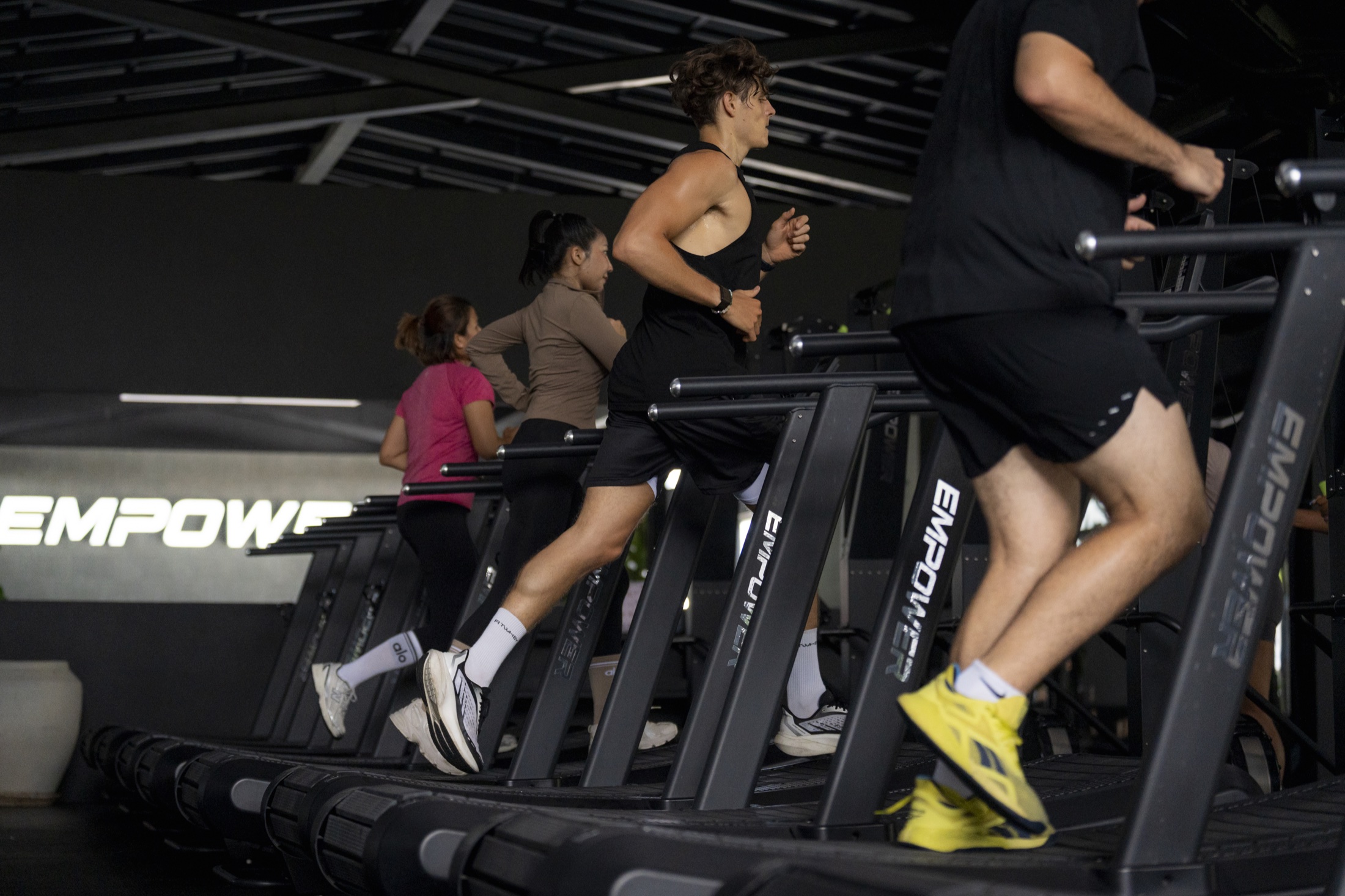 Athletes running together during HYROX training at EMPOWER