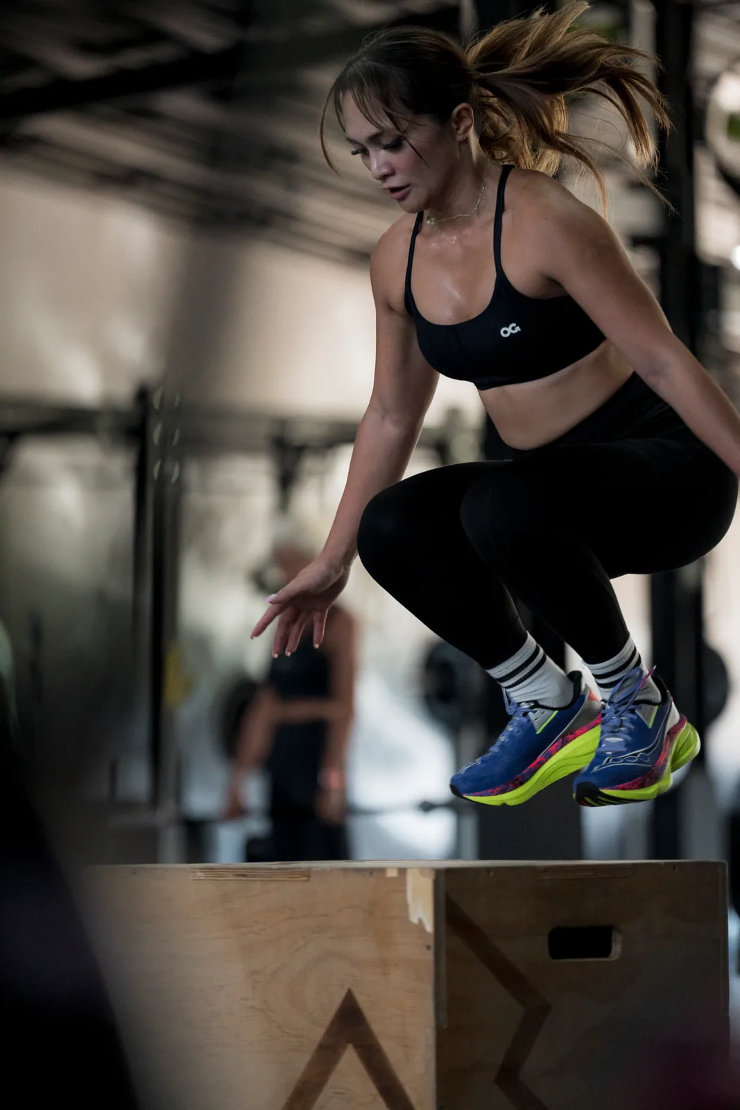 Athlete landing a box jump during an EMPOWER workout