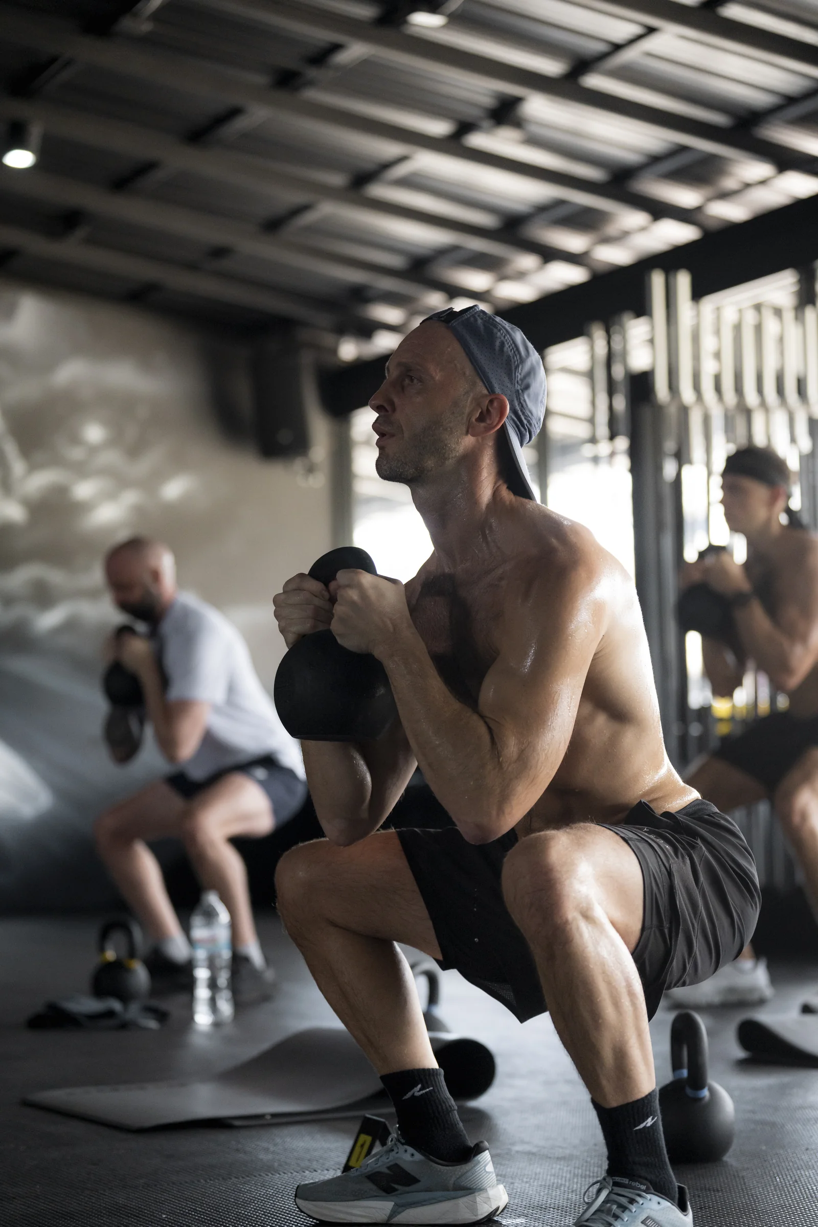 Athlete holding a kettlebell during a squat at EMPOWER