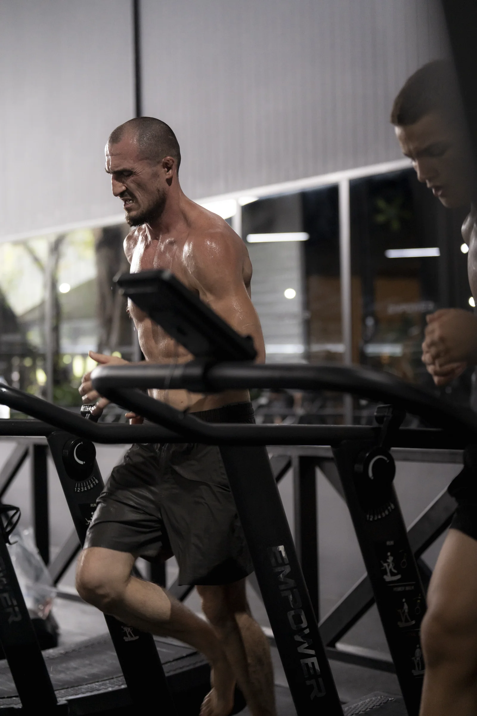 Athletes running on curved treadmills at EMPOWER