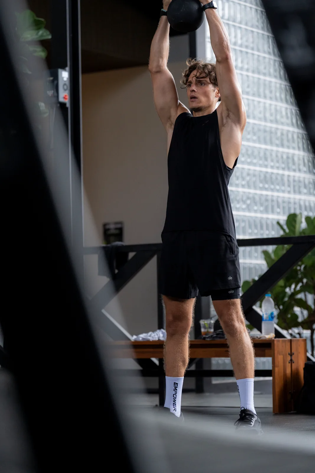 Athlete reaching overhead during a September class