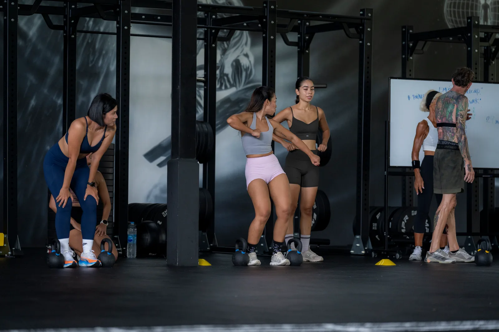 Training partners sharing a laugh between sets at EMPOWER