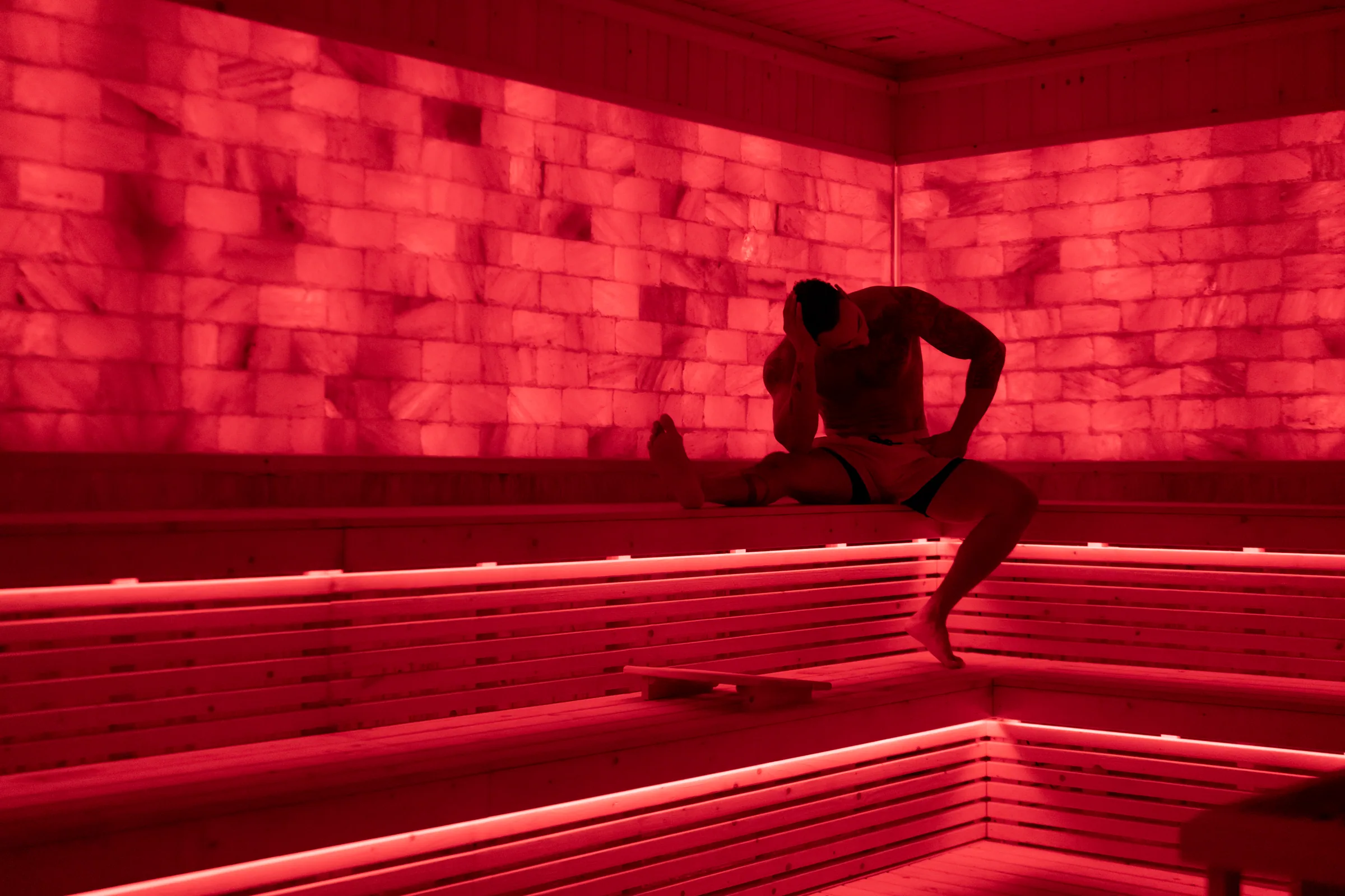 Guest recovering inside the red-light Himalayan salt sauna at EMPOWER