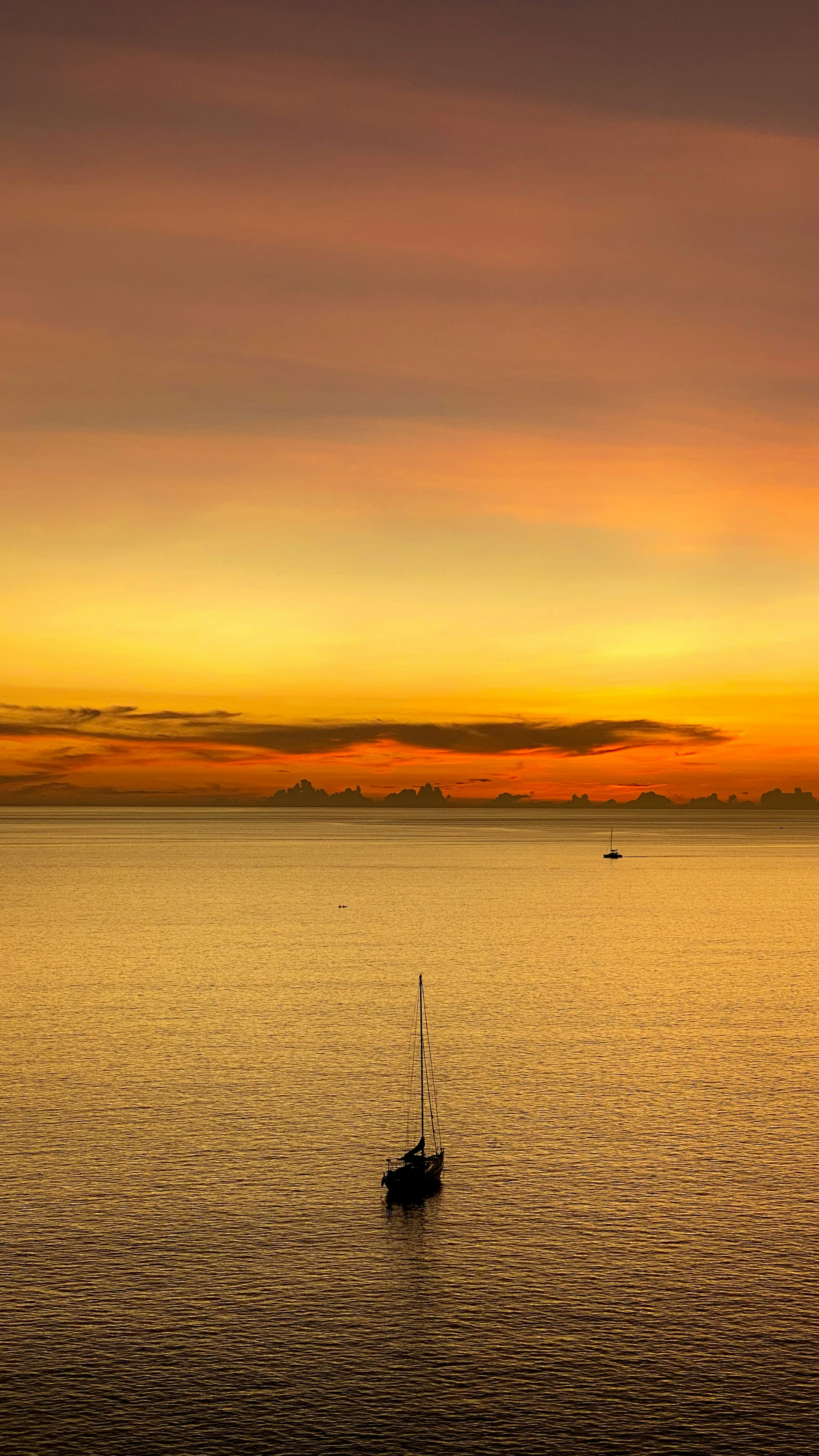 A sailboat on the Andaman Sea at sunset in Phuket