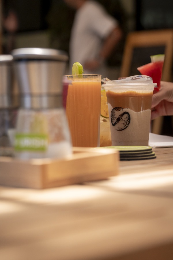 Fresh juice and a branded smoothie from NOURISH