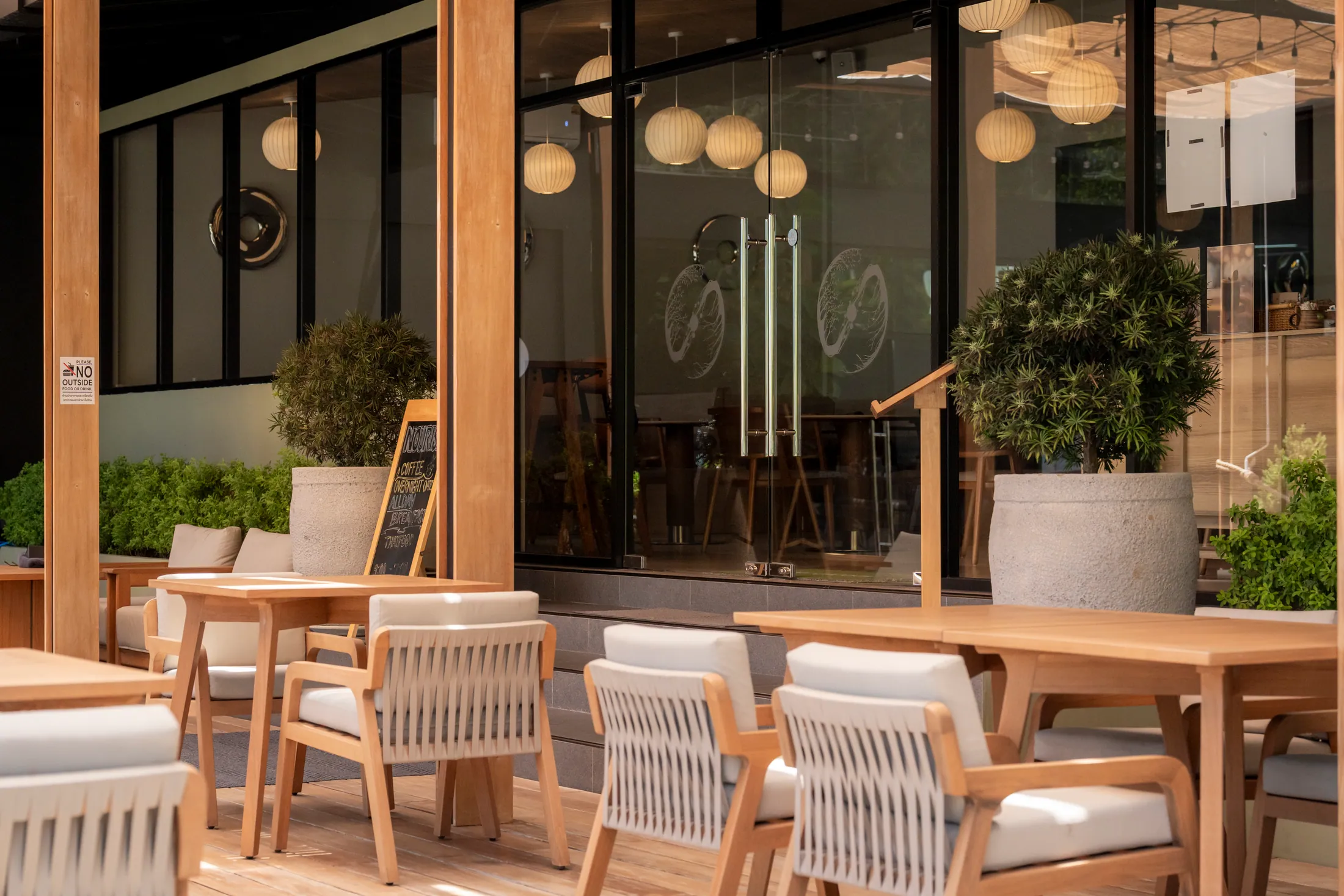 Sunlit outdoor dining terrace at NOURISH in Kamala